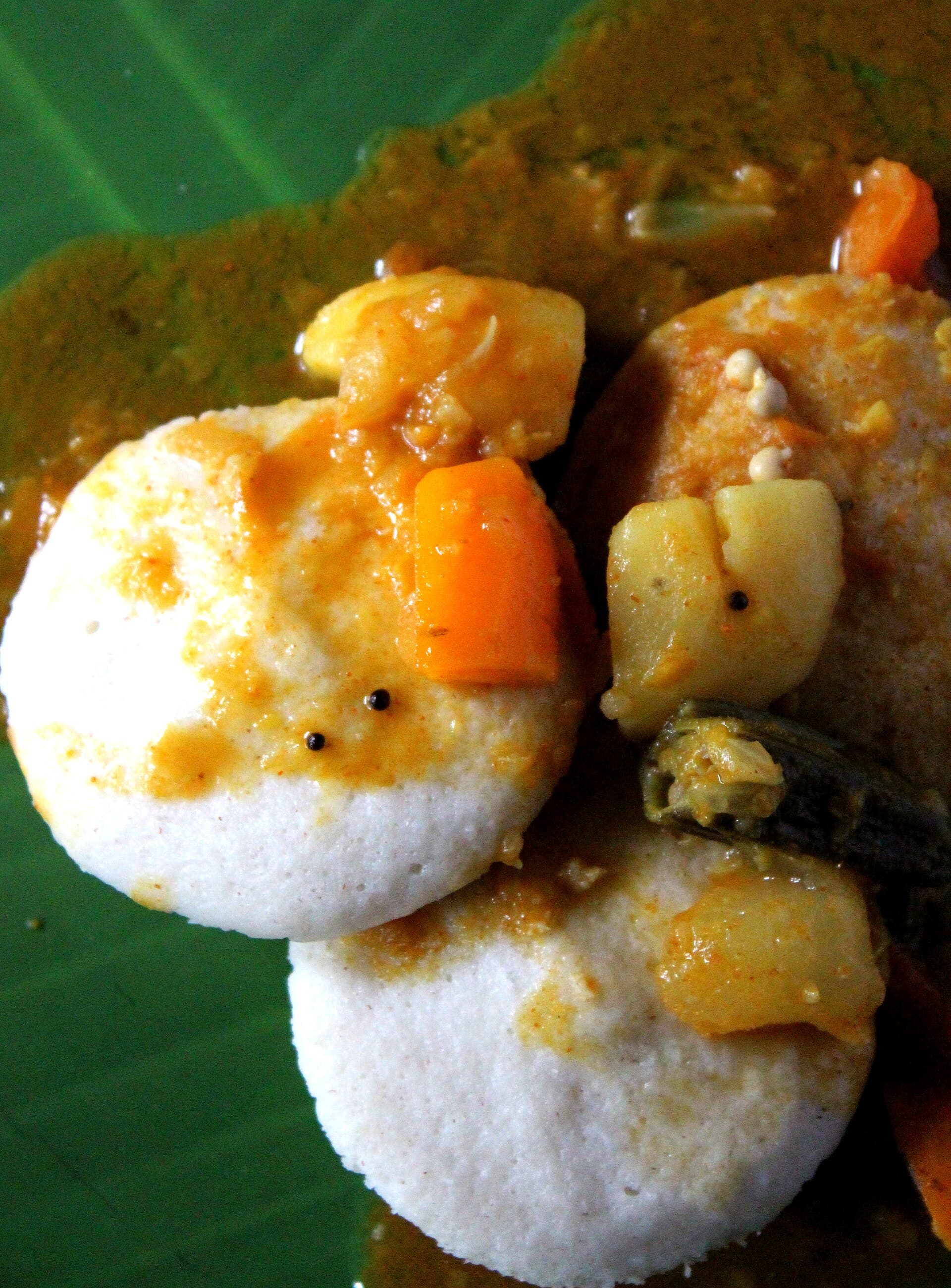 Idli with sambar on a banana leaf